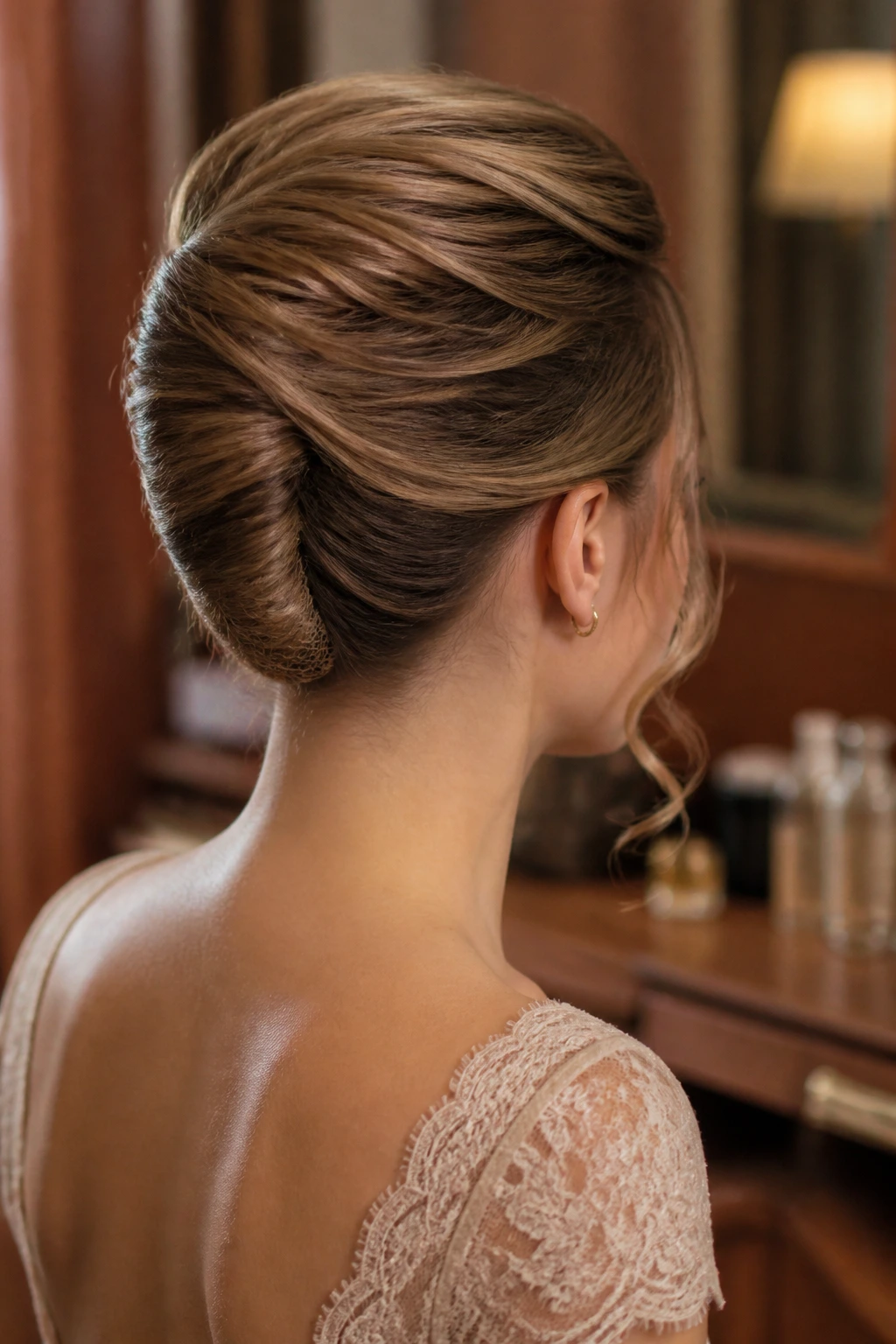 Back/side view of a real woman with a structured French twist and hair net