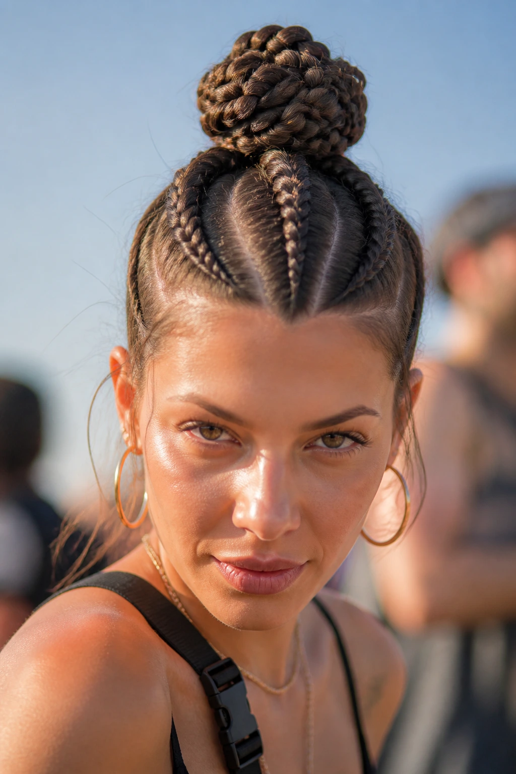 Close-up of a real person with three braids converging into a top knot