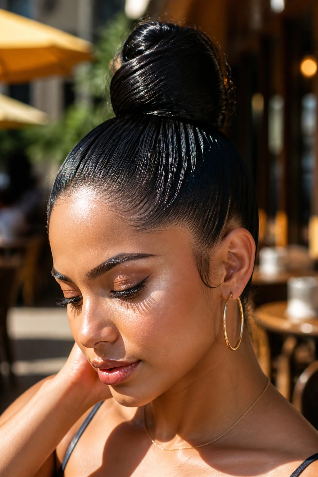 Close-up of a real woman with a high sleek topknot outdoors