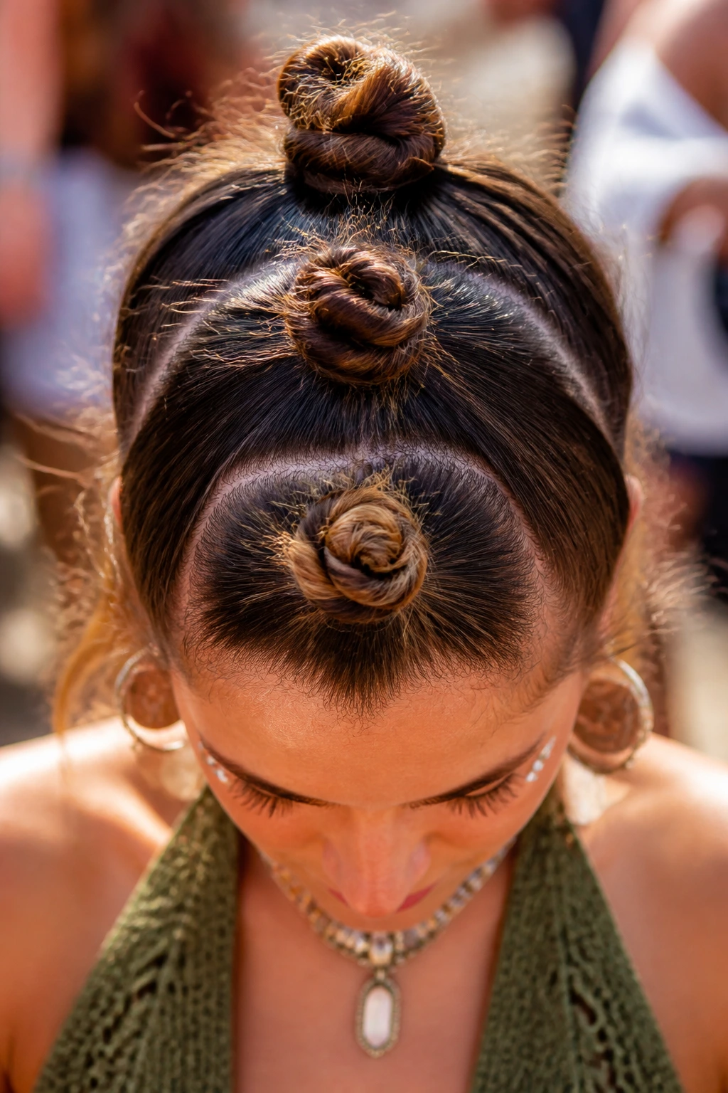 Three mini buns stacked along the center of the head on a real person