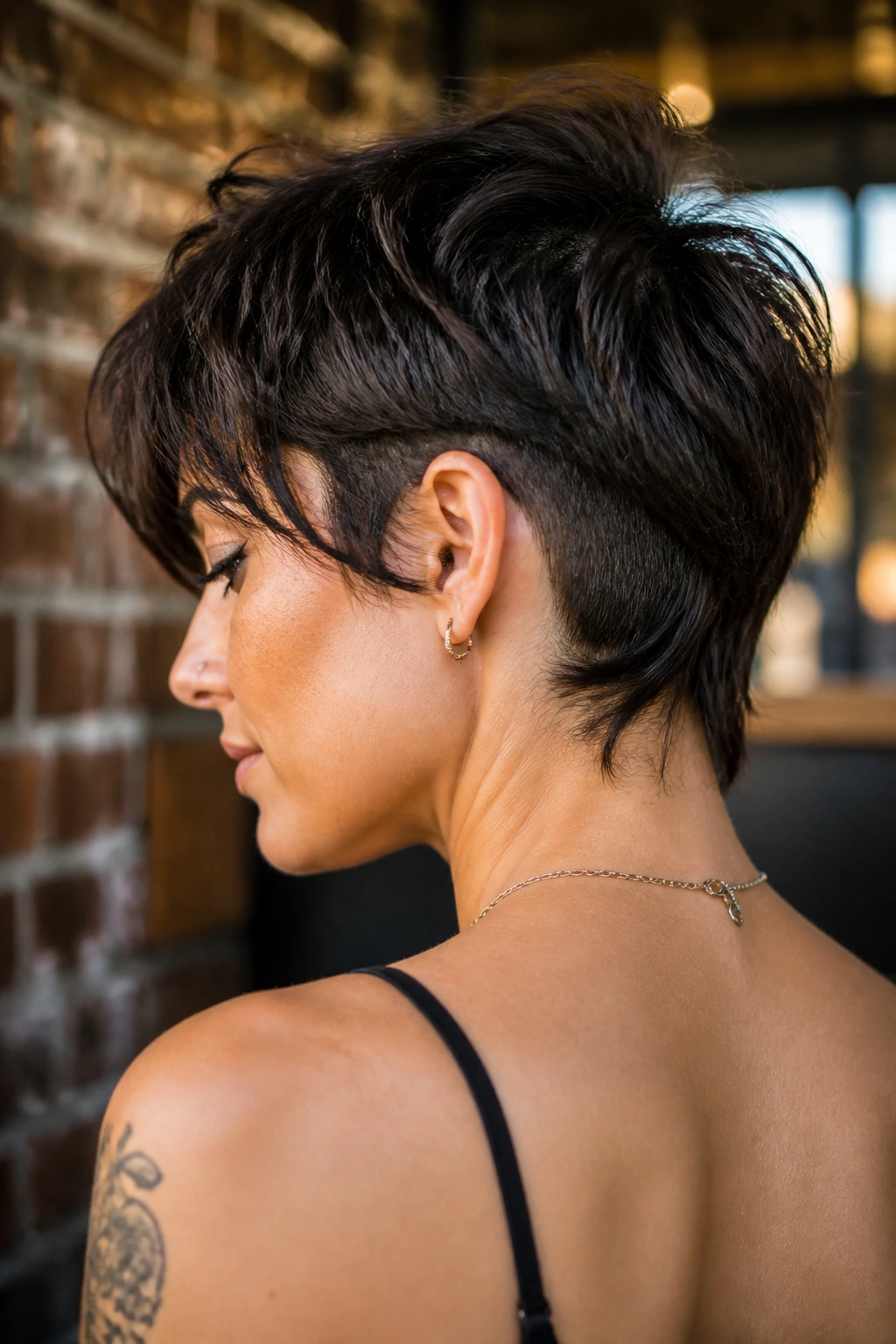 Close-up of a real woman with edgy undercut shag showing nape undercut.