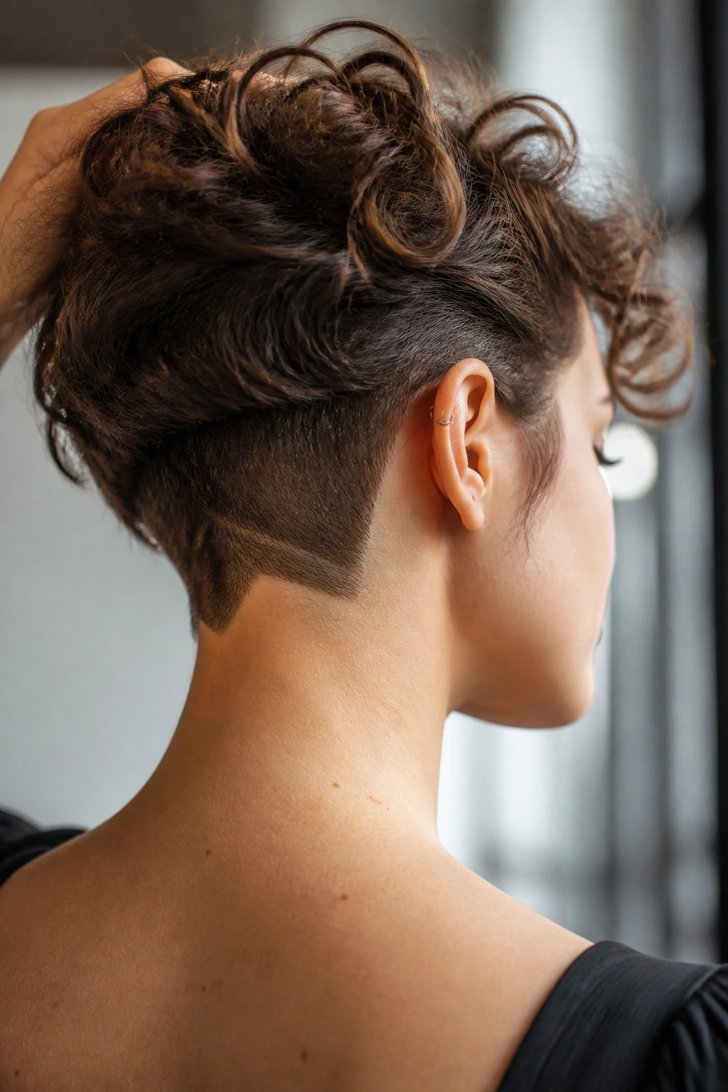 Portrait showing undercut variations including a notch and curls on top
