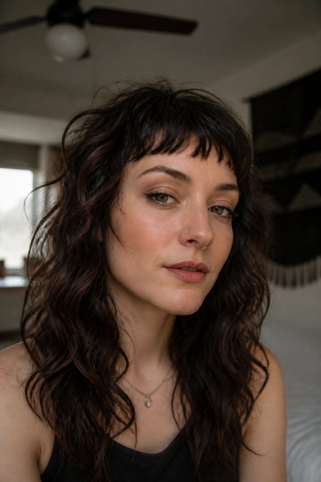 Close-up of a real person with wavy baby bangs and alt-grock shag waves in natural light.
