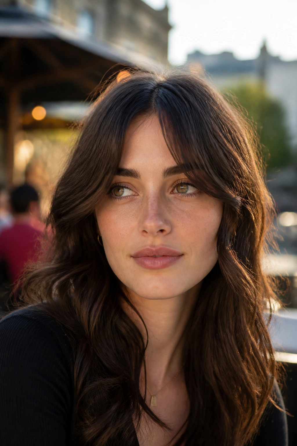 Close-up of real woman with wavy bottleneck tendrils outdoors at golden hour
