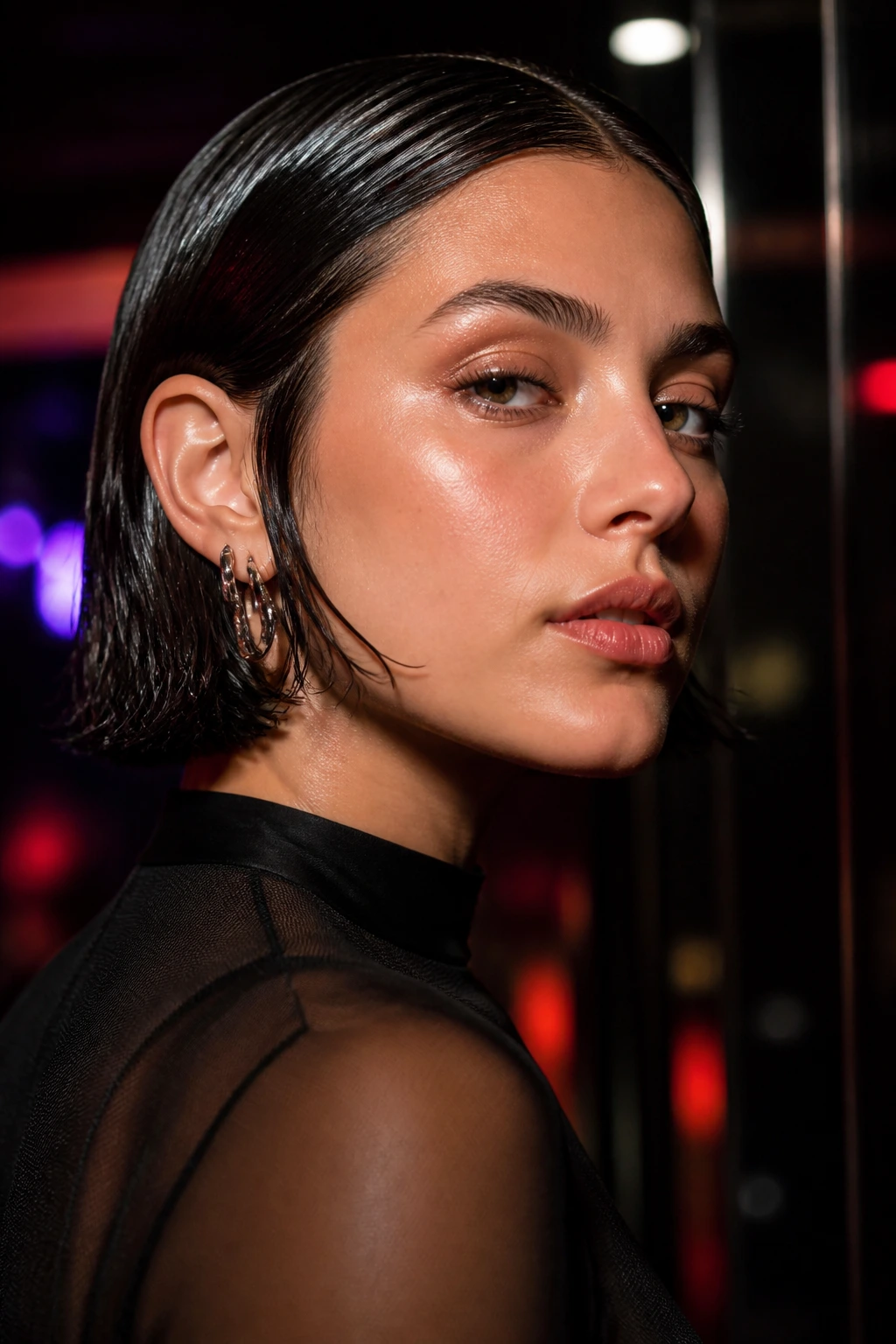 Close-up portrait of a real woman with a shiny wet-look French bob in an urban nightlife setting