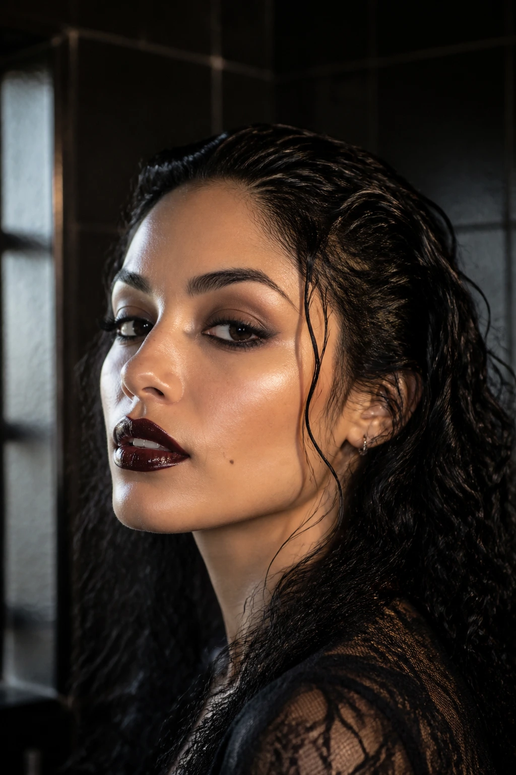Close-up of a real woman with glossy wet-look curls swept back.