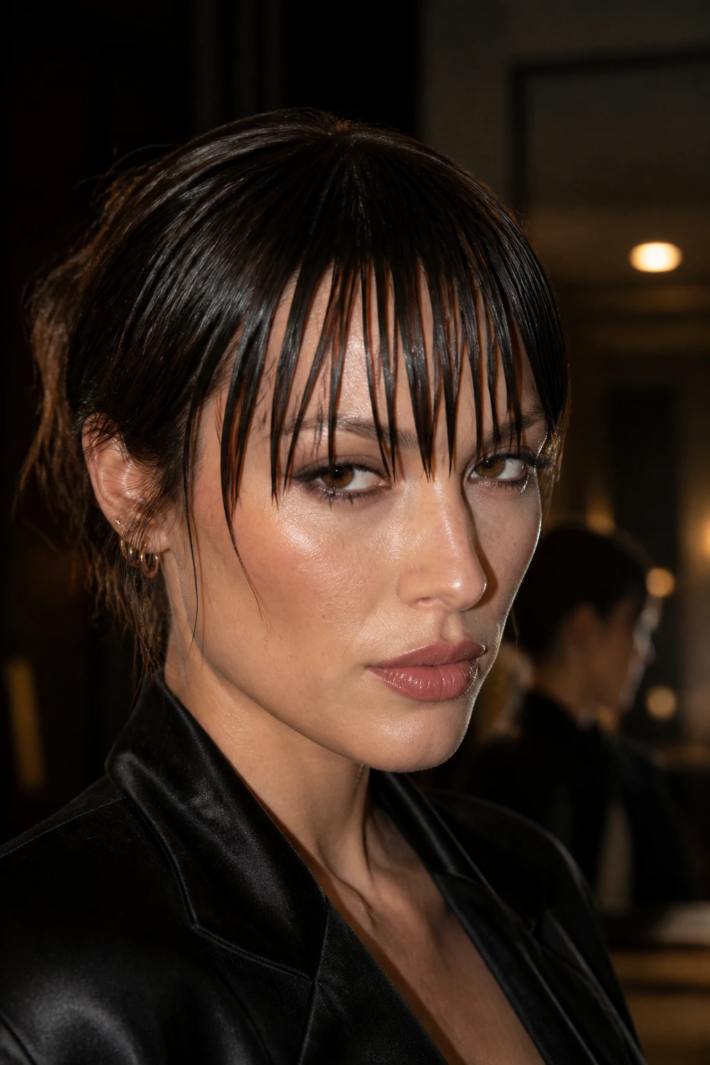 Portrait of a real woman with a glossy wet-look fringe and deliberate separation.