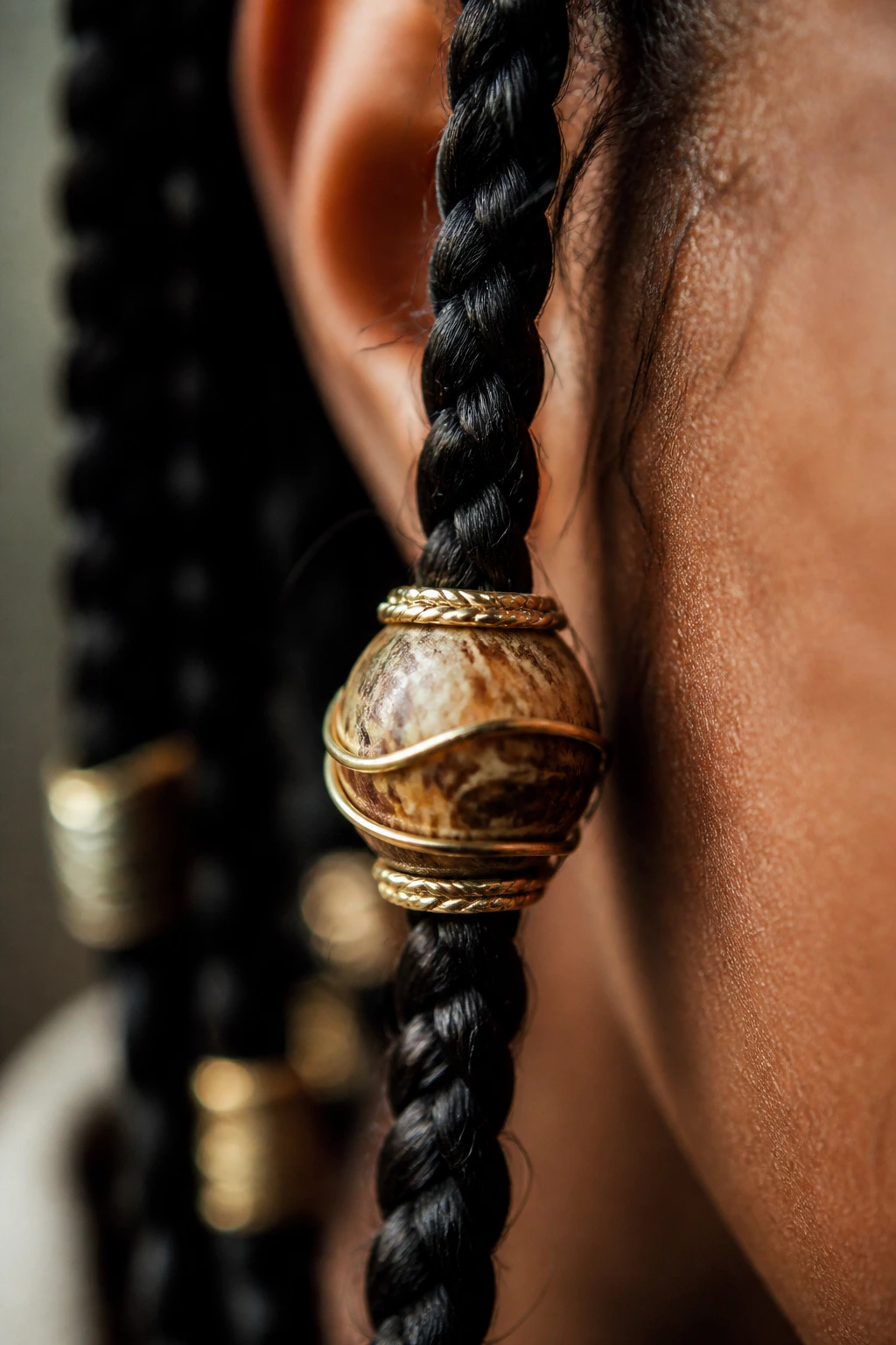 Close-up of a bead with decorative wire accent on a braid