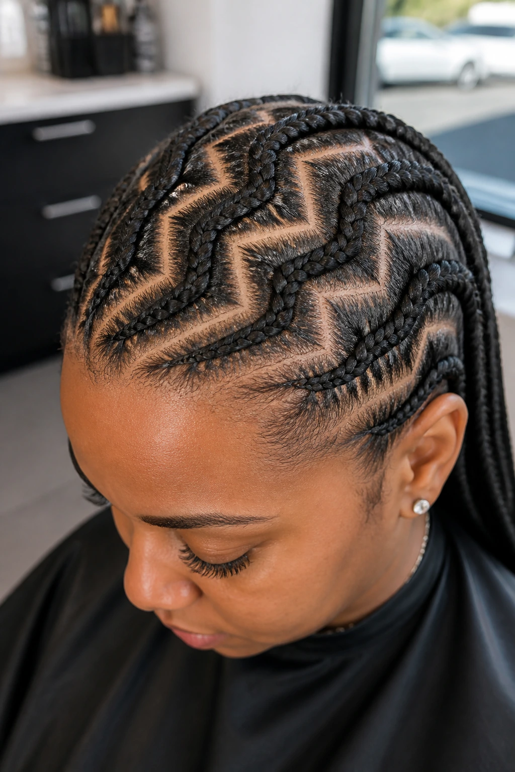 Close-up of zig-zag cornrow partings on a real person's scalp