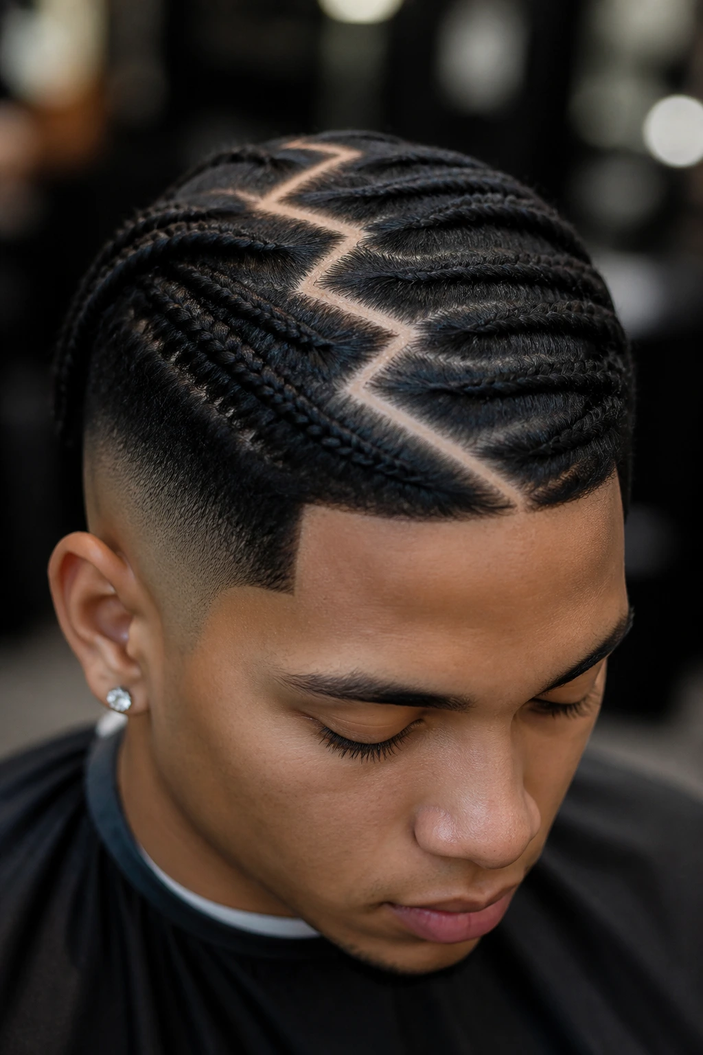 Close-up of real person showing a bold zig-zag scalp part for a tribal-inspired look.
