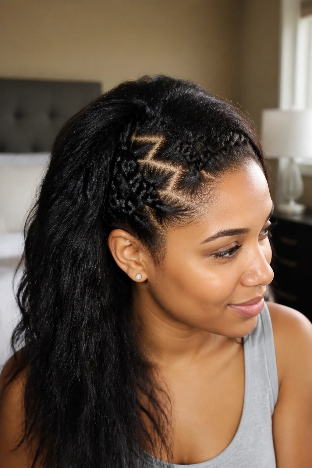 Close-up portrait of a real woman with a zig-zag invisible braid on thick hair, natural window light.