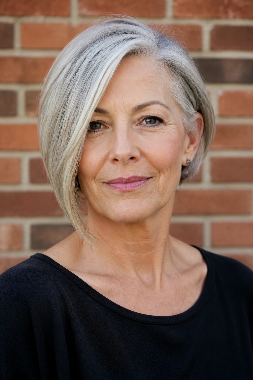 Close-up of a real woman with an asymmetrical bob against a brick wall