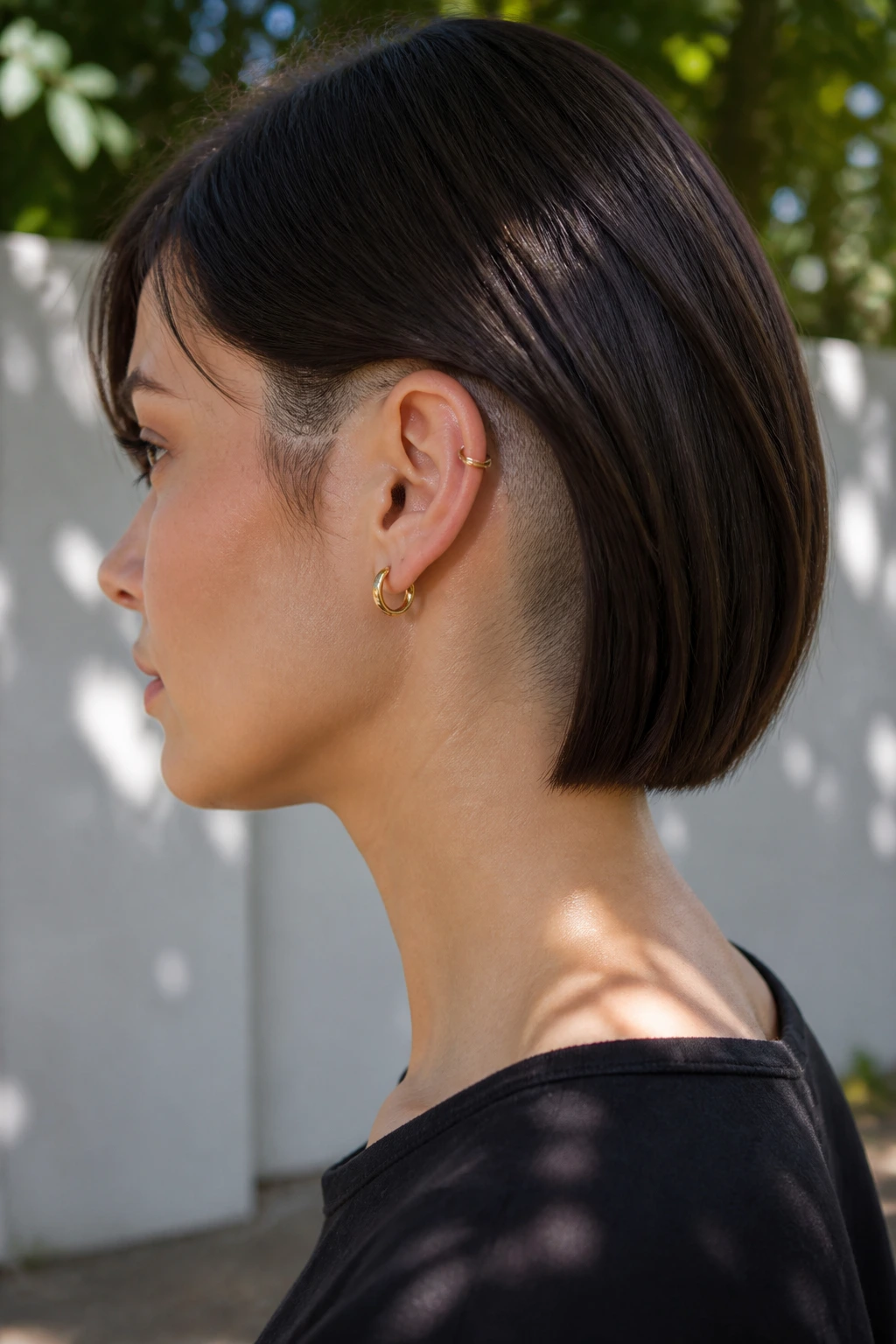 Side-profile of a real woman with blunt neck-length cut and hidden nape undercut