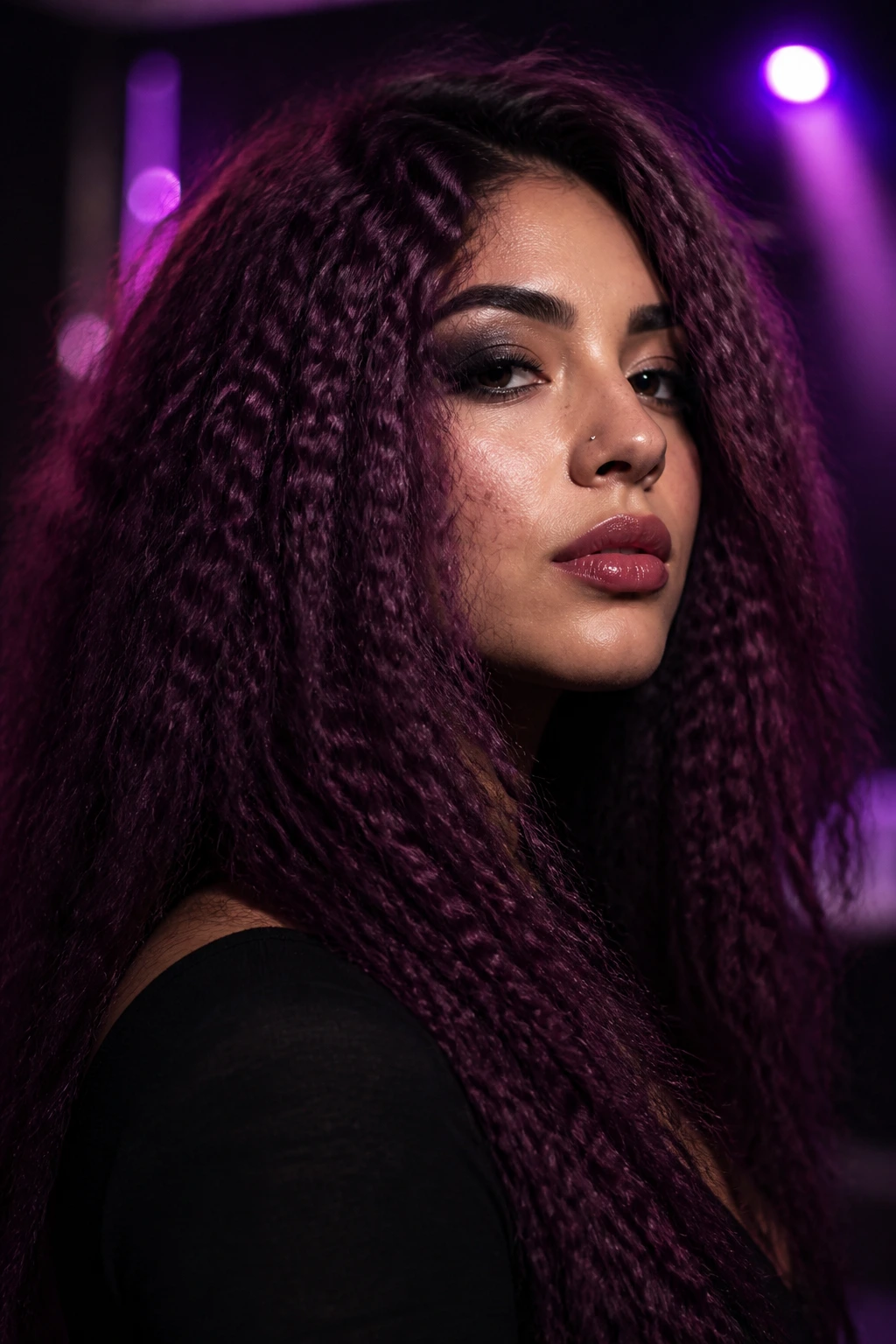 Close-up of a real woman with crimped plum hair in club lighting