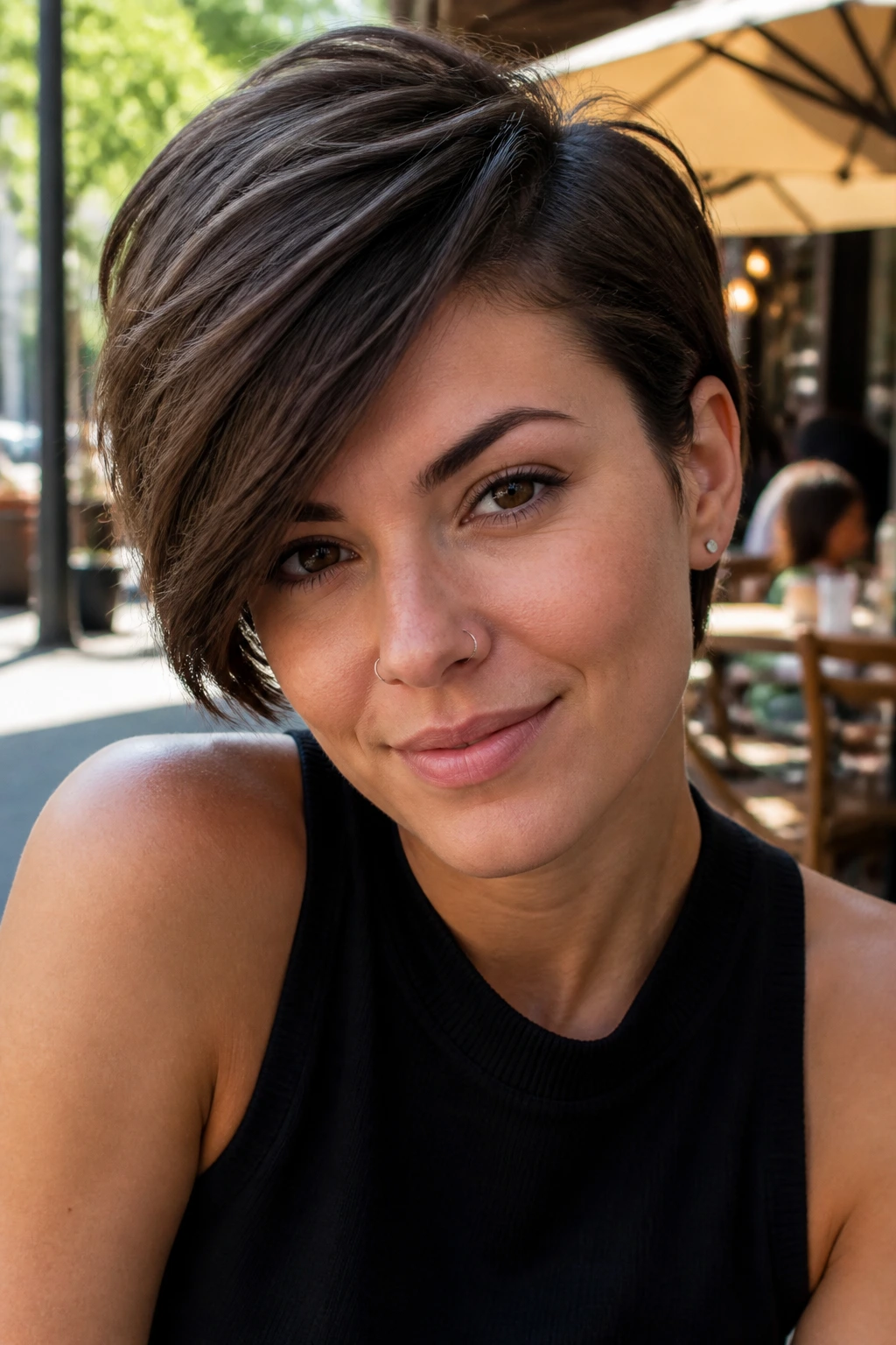 Close-up portrait of a woman with a deep side-parted pixie cut in outdoor daylight