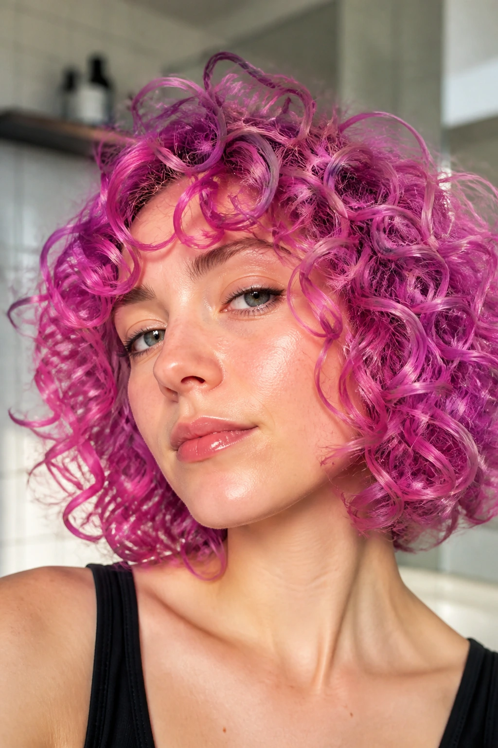 Close-up of a real person with electric violet-pink curly bob