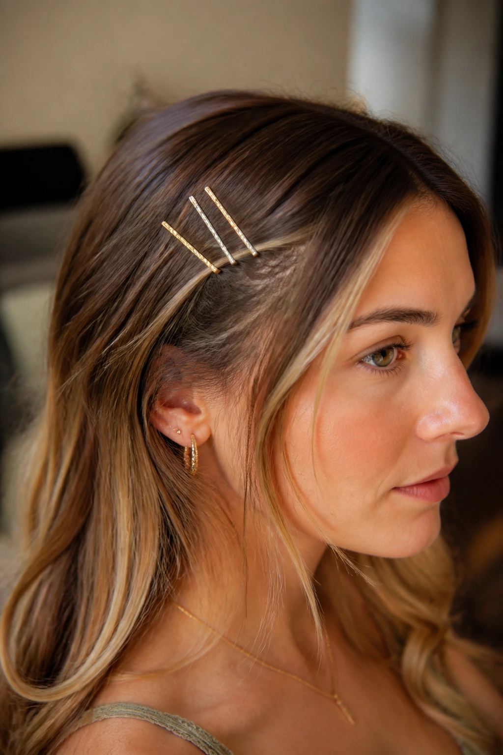 Close-up of a real person with foil-wrapped bobby pins tucked in hair.