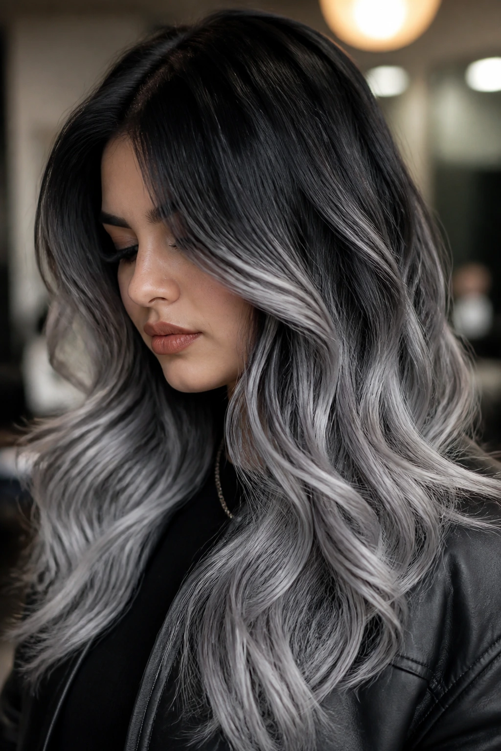 Close-up of Latina woman with black-to-silver root fade hair