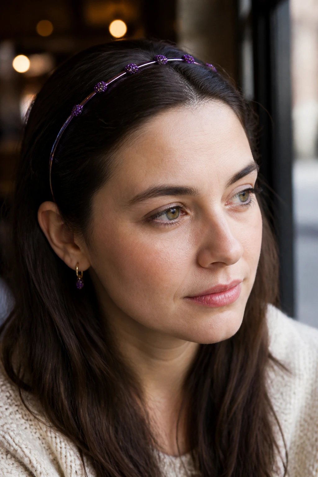 Close-up of a real woman with a glitter-accents headband on hair.