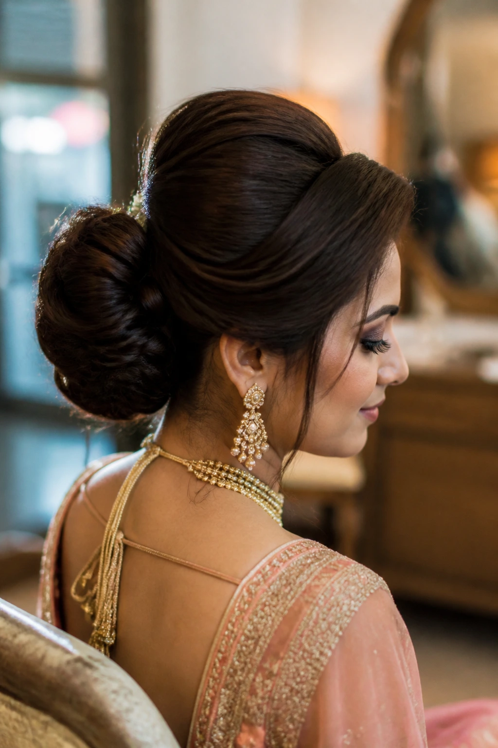 Close-up of a real woman with a high volume chignon under warm window light