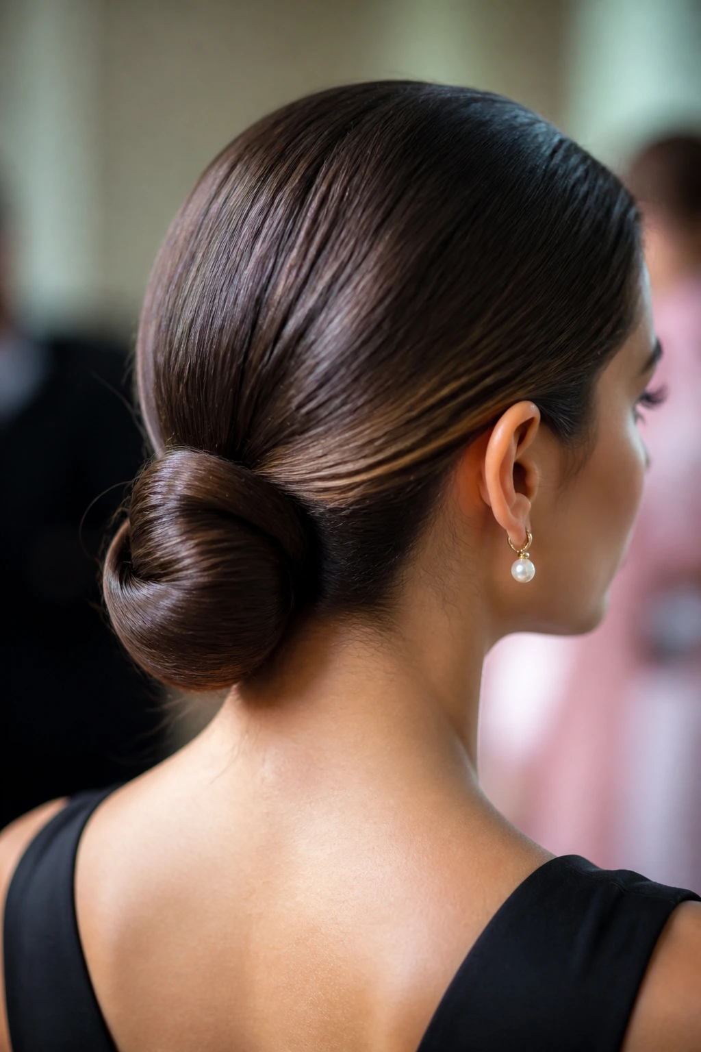 Portrait of a real person with a low, polished chignon at the nape