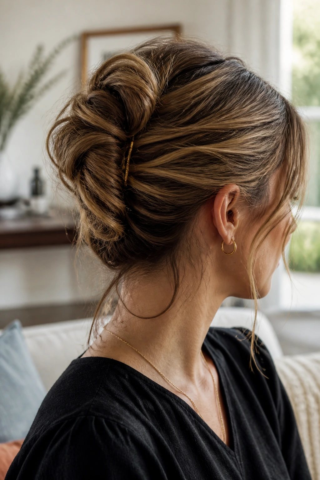Close-up of a real woman with a messy French twist hairstyle