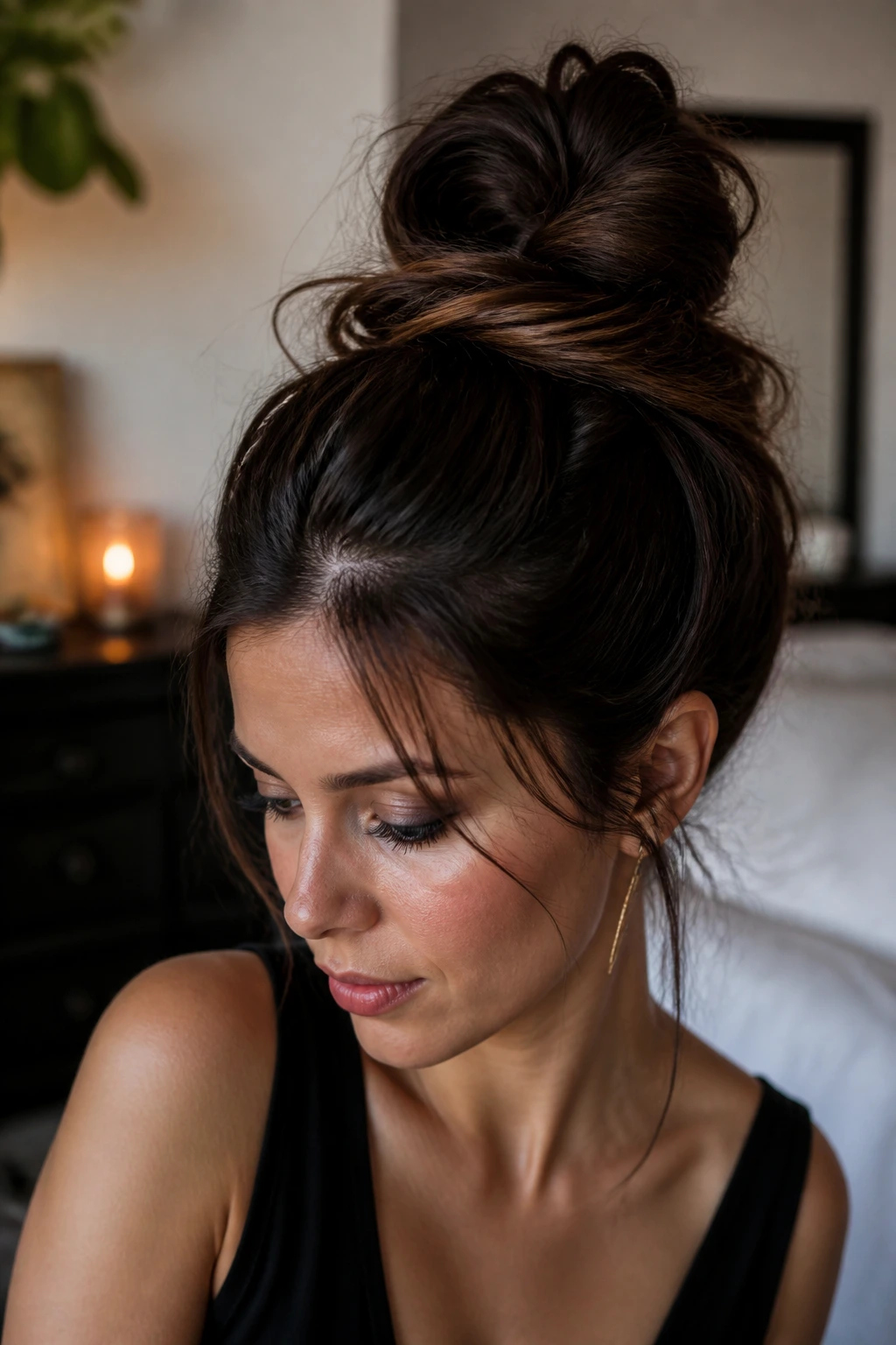 Portrait of a real woman with a loose, wide messy top knot.