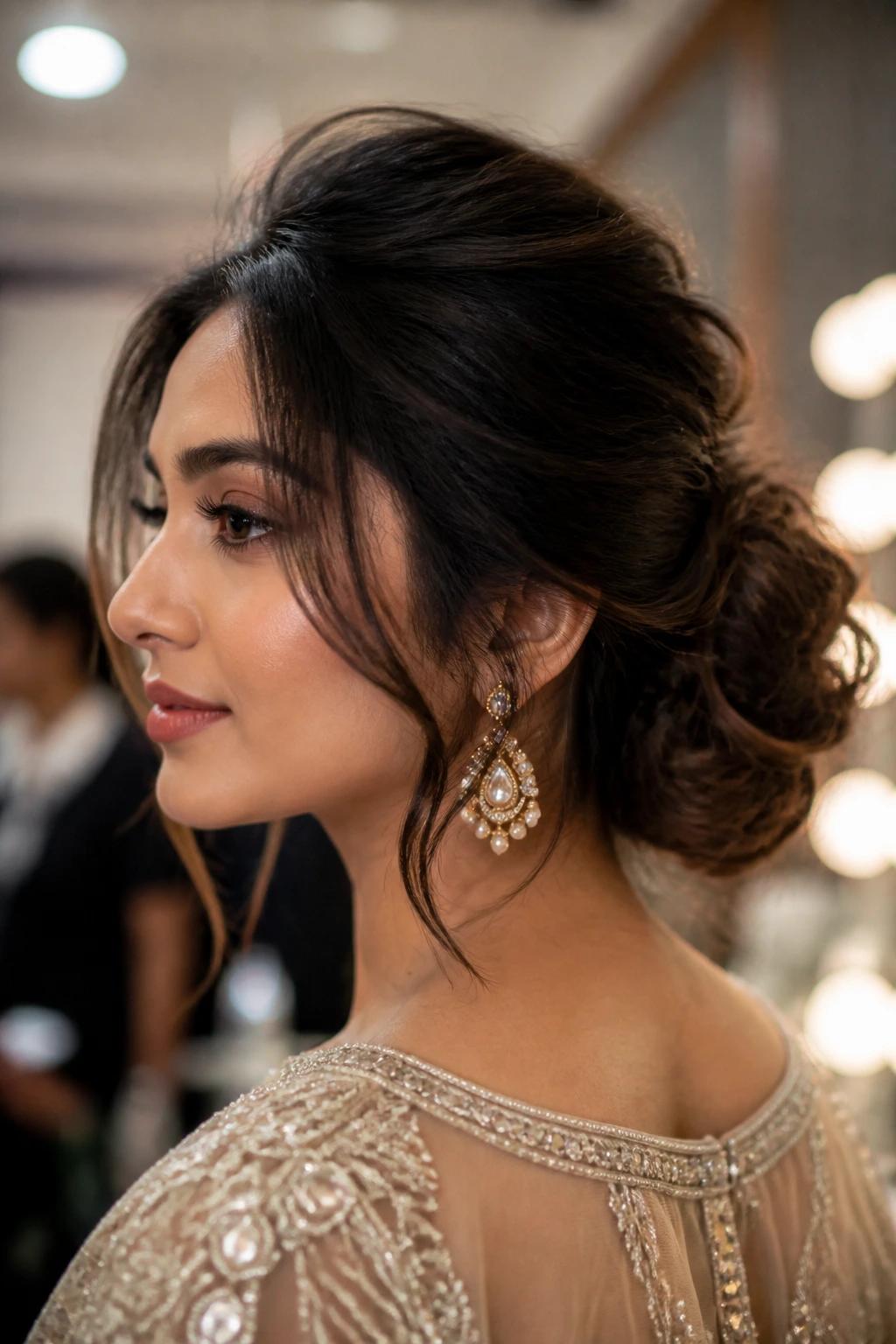 Close-up of a real woman with a modern chignon and soft front volume