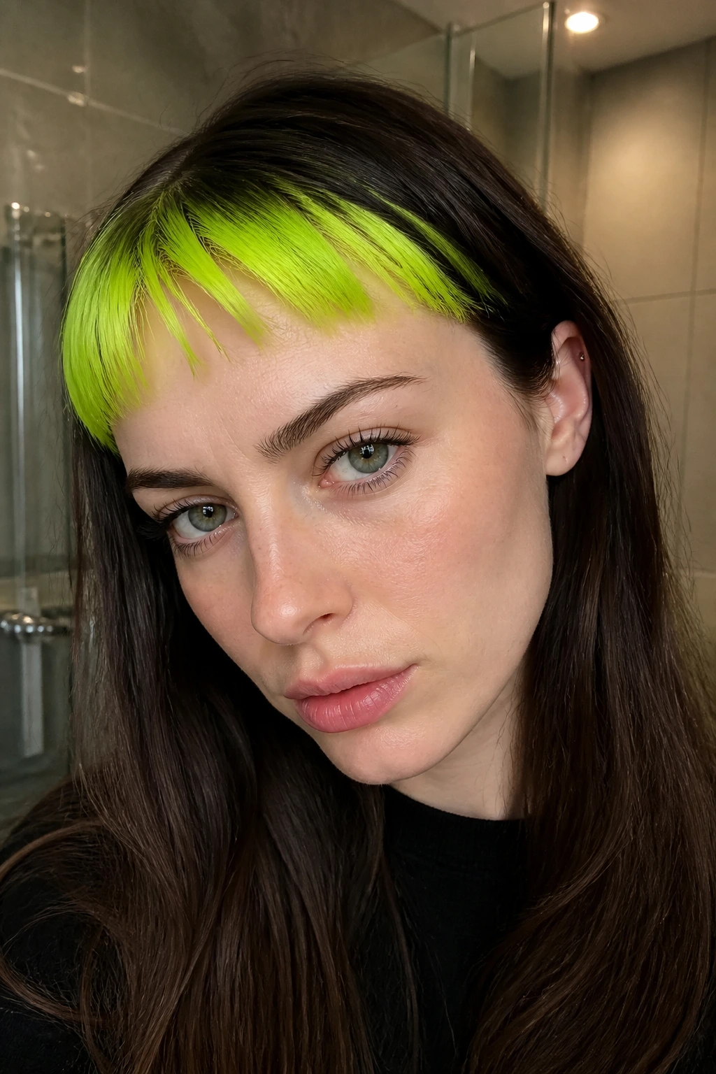 Close-up portrait of a real person with neon green micro-bangs
