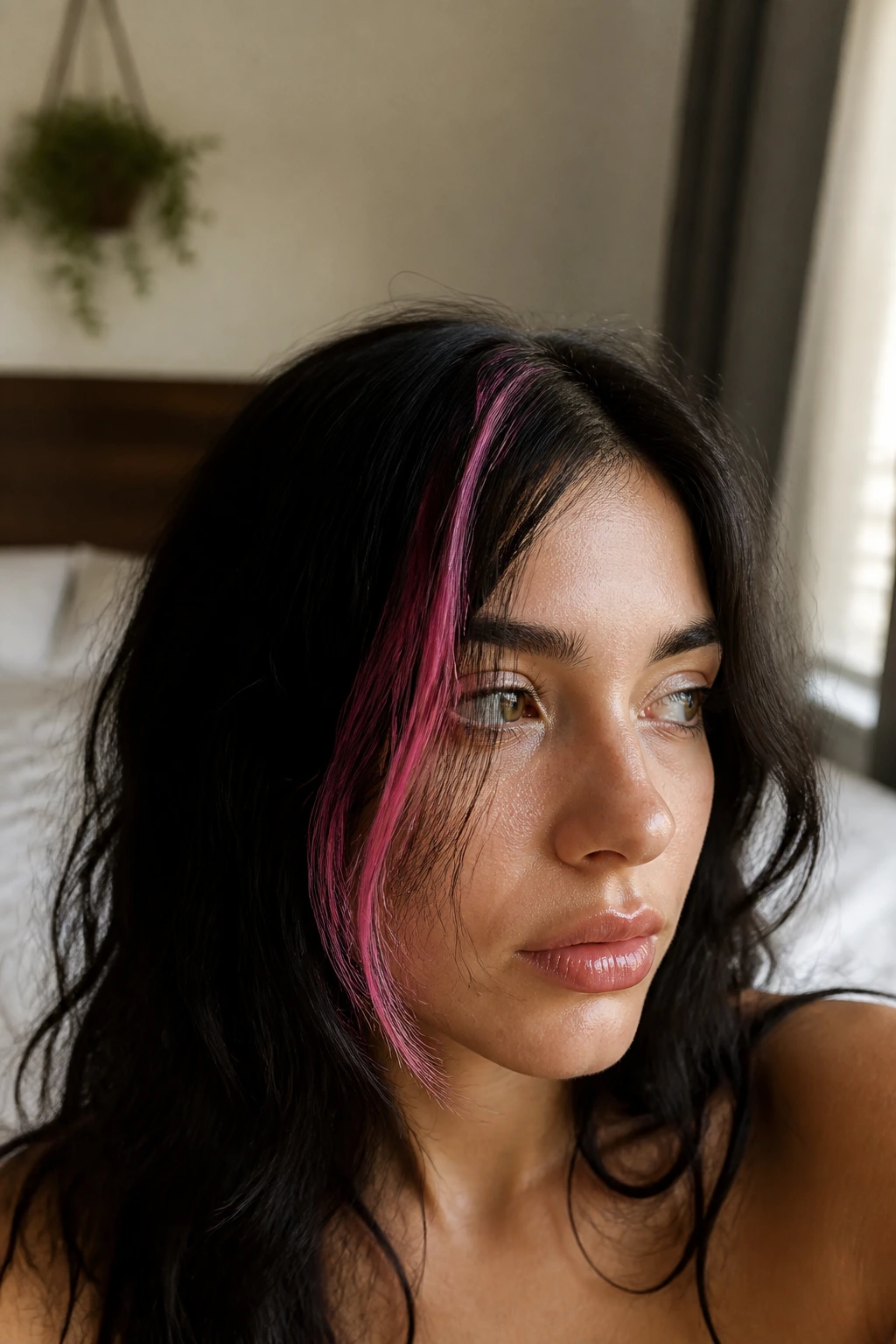 Close-up portrait of a real person with a neon pink front hair stripe against dark hair.