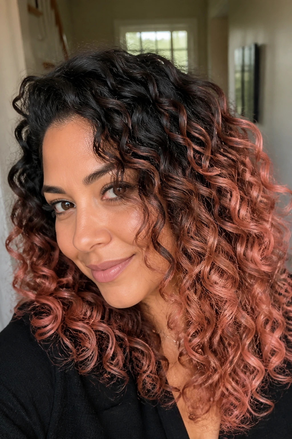 Portrait of a real person with dark roots and rose gold accents