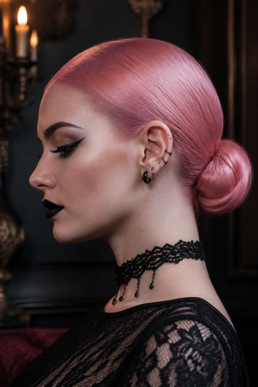 Close-up portrait of a person with a slicked pink low bun in a gothic interior.