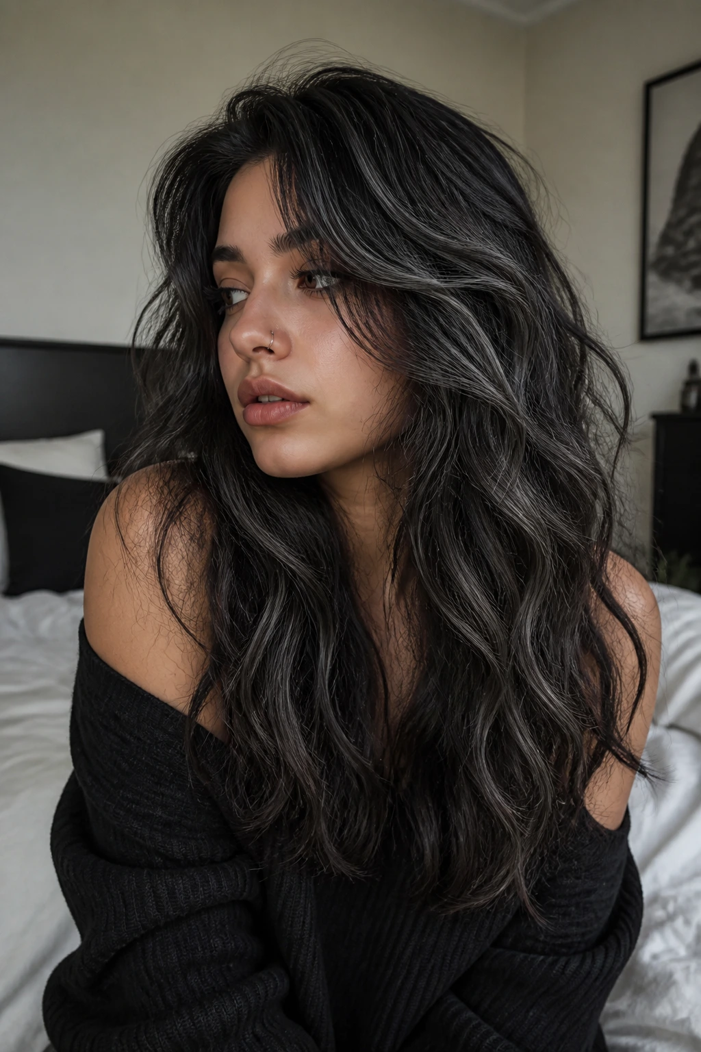 Medium close-up of a real woman with soft wavy hair and ash-grey highlights in a bedroom