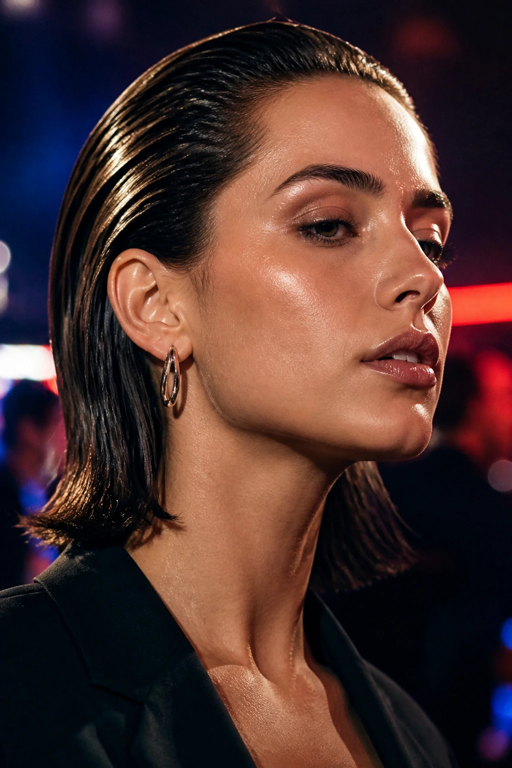 Close-up portrait of a person with a wet-look lob slicked back