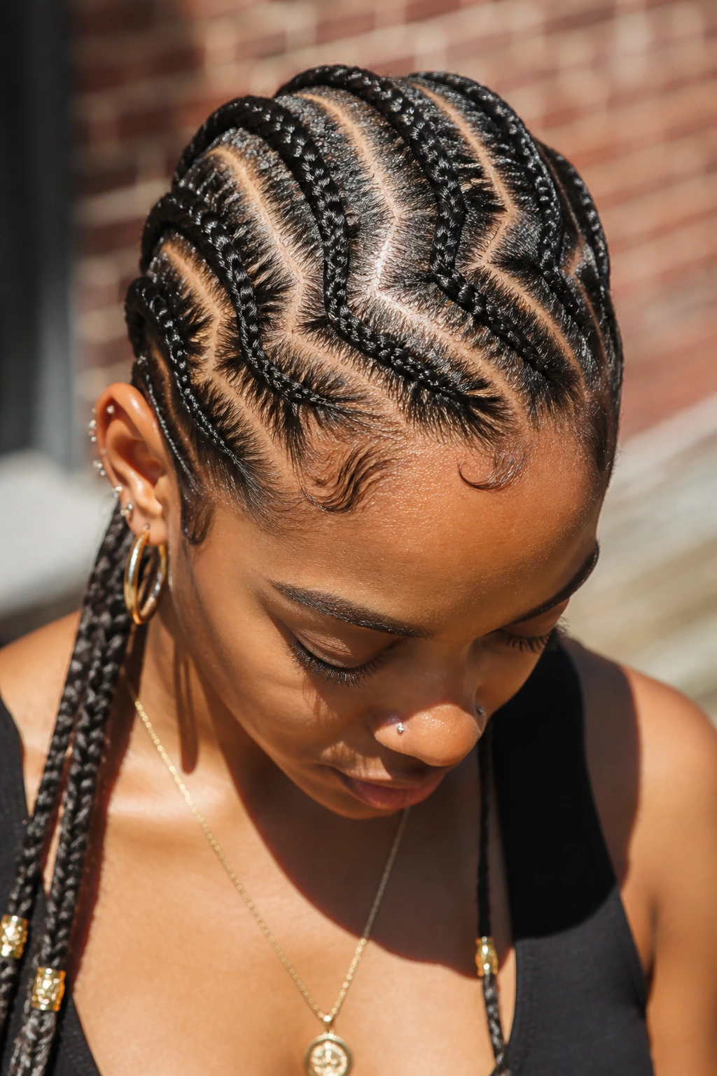 Close-up portrait of a real person with zig-zag parting cornrows.